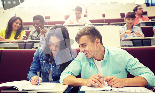 Image of group of students with notebooks at lecture hall