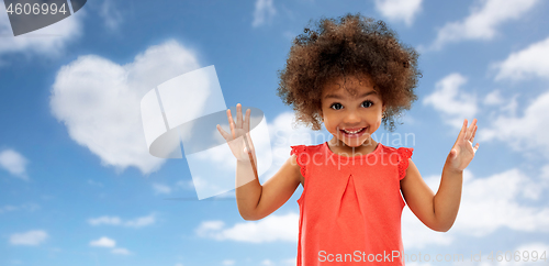 Image of happy little african american girl over blue sky