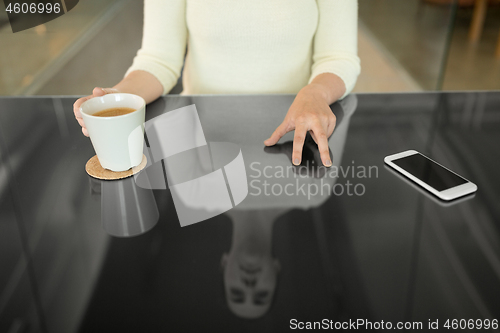 Image of woman with coffee using black interactive panel