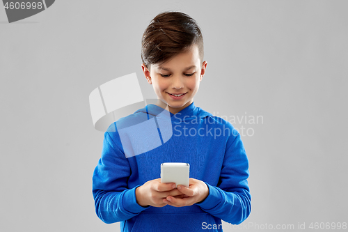 Image of smiling boy in blue hoodie