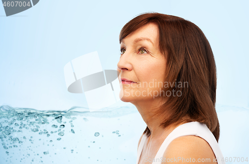 Image of portrait of senior woman over blue water