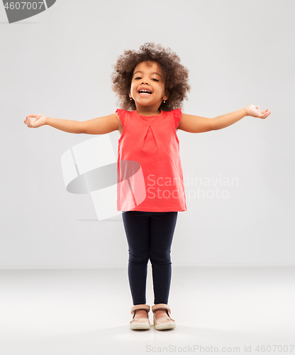 Image of happy little african american girl with arms apart