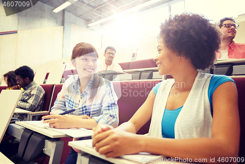 Image of group of international students talking on lecture