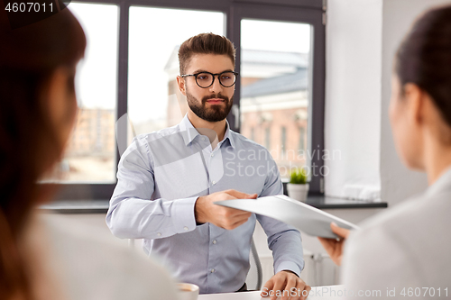 Image of male employee having job interview with recruiters