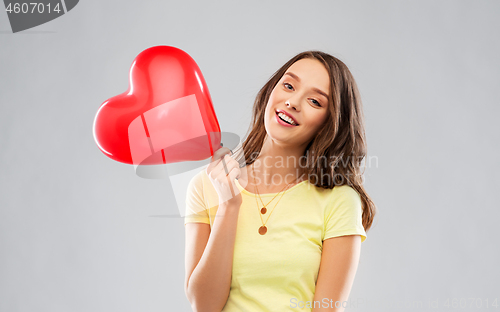 Image of teenage girl with red heart-shaped balloon