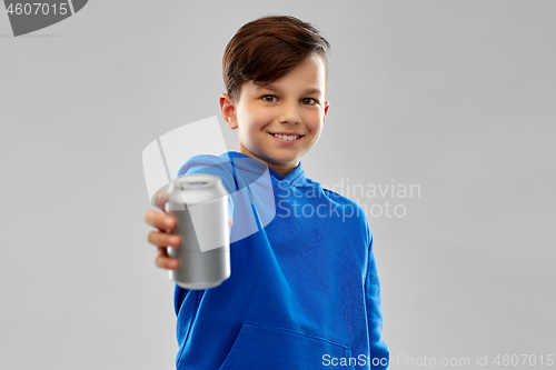 Image of smiling boy in blue hoodie holding can drink