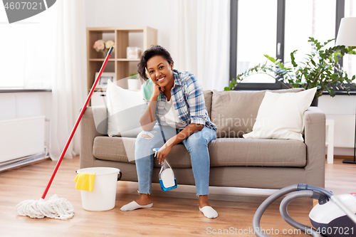 Image of african woman or housewife after cleaning at home