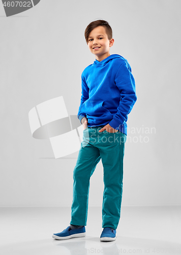 Image of smiling boy in blue hoodie