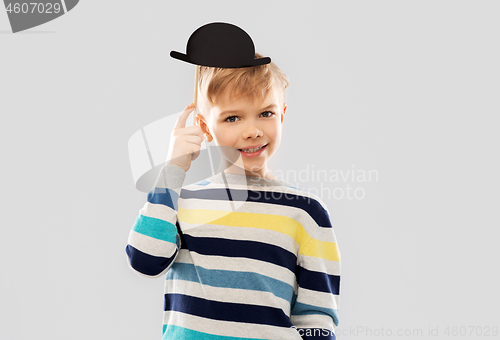 Image of smiling boy with black vintage bowler hat