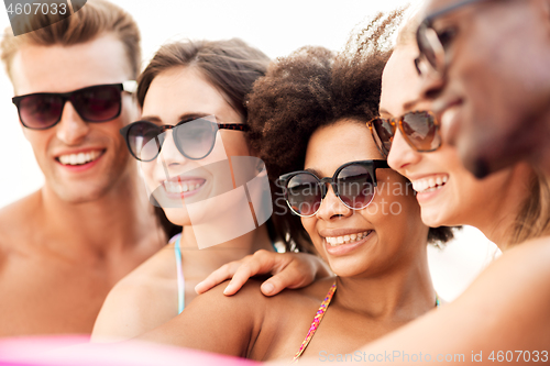 Image of close up of happy friends in sunglasses in summer