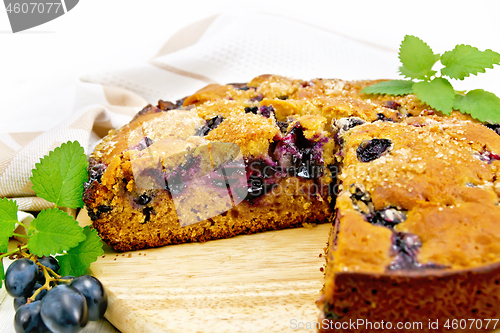 Image of Pie with black grapes on board