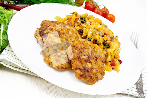 Image of Fritters meat with cabbage in plate on light board