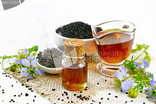 Image of Oil kalingi in bottle and gravy boat on wooden board