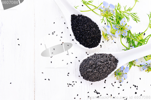 Image of Flour and seeds of kalingi in spoons on board top