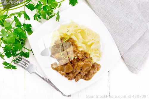 Image of Goulash of beef with mashed potatoes in plate on board top