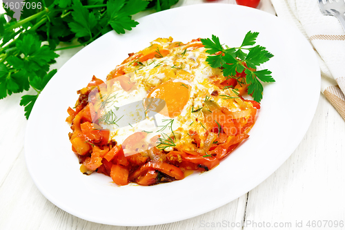 Image of Scrambled eggs with vegetables in plate on light board