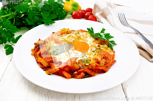 Image of Scrambled eggs with vegetables in plate on white board