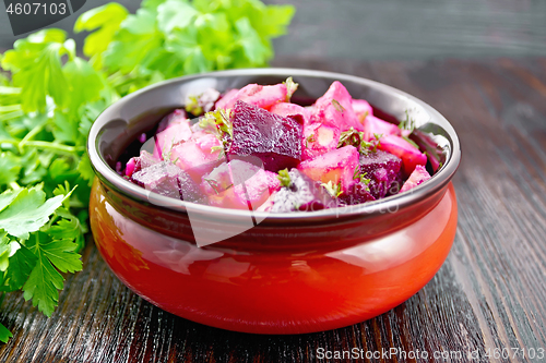 Image of Salad of beets and potatoes in bowl on dark table