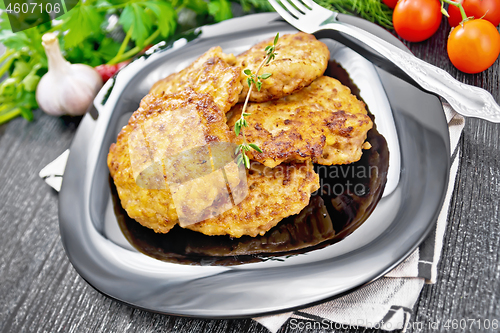 Image of Fritters meat in plate on black wooden board