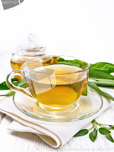 Image of Tea herbal with sage in cup on light wooden board