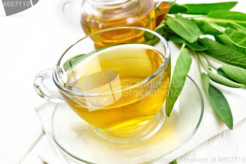 Image of Tea herbal with sage in cup on light board