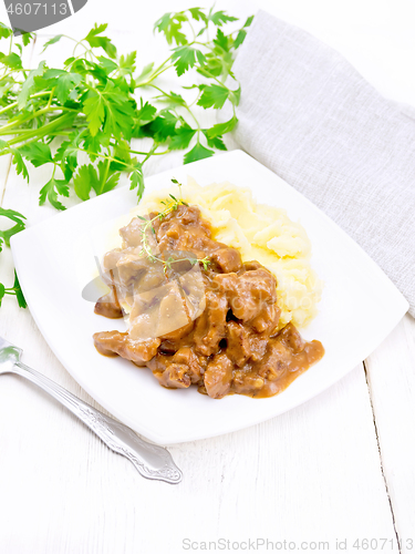 Image of Goulash of beef with mashed potatoes in plate on table