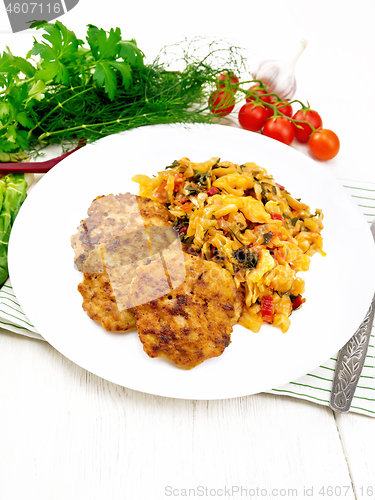 Image of Fritters meat with cabbage in plate on towel