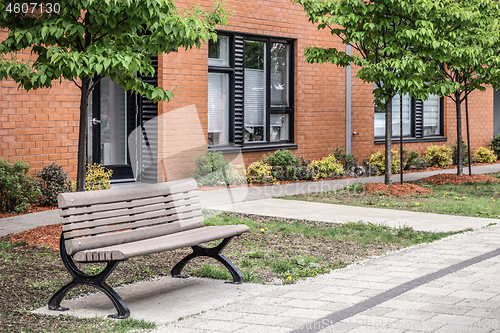 Image of Bench in front of a modern brick building