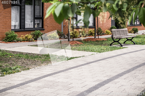 Image of Paved path leading to a modern brick building