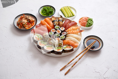 Image of Various sushi rolls placed on round ceramic plate