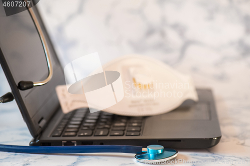 Image of Stethoscope and notebook Tablet in the fingers of hand