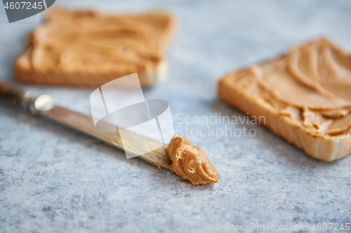 Image of Two tasty peanut butter toasts placed on stone table