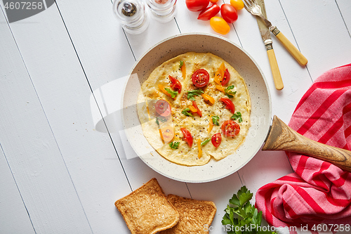 Image of Tasty homemade classic omelet with cherry tomatoes