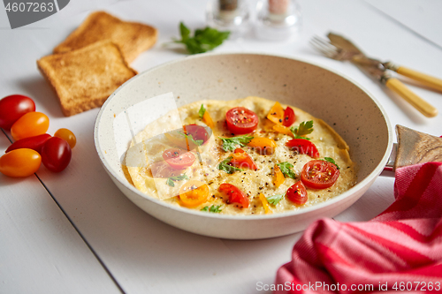 Image of Tasty homemade classic omelet with cherry tomatoes