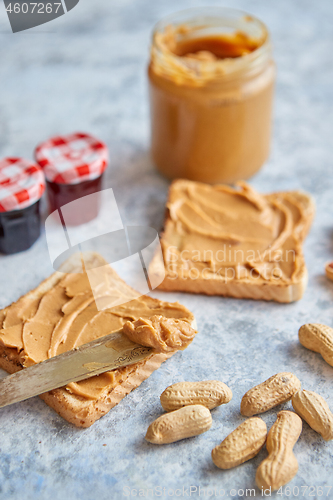 Image of Two tasty peanut butter toasts placed on stone table