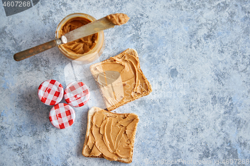 Image of Two tasty peanut butter toasts placed on stone table