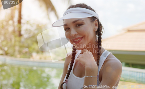 Image of Cheerful sportswoman smiling for camera