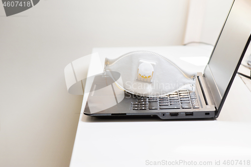 Image of Black notebook with protecting mask on the table. Coronavirus concept. Work from home concept