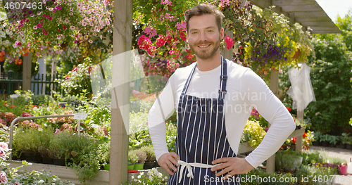 Image of Smiling handsome gardener man standing and posing