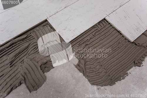 Image of Ceramic wood effect tiles and tools for tiler on the floor