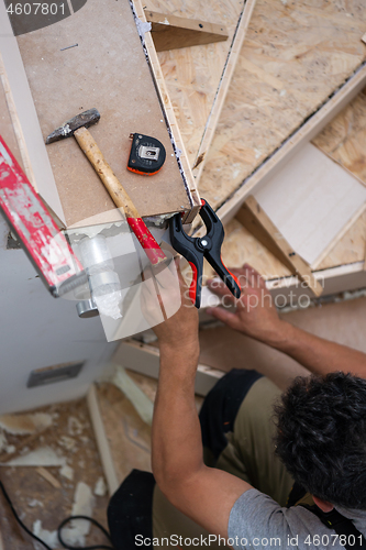 Image of carpenter installing wooden stairs