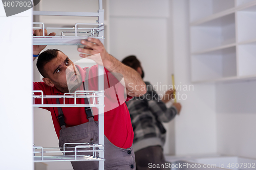 Image of workers installing a new kitchen