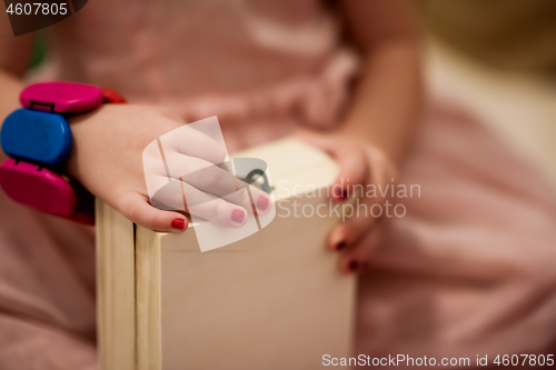 Image of little girl enjoying while playing with mother\'s jewelry