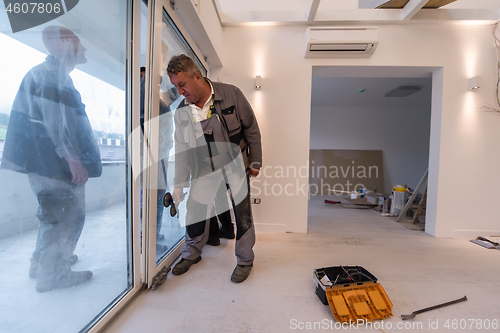 Image of carpenters installing a balcony door