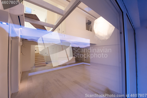 Image of outside view trough window on two level apartment interior