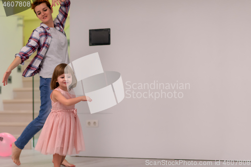 Image of mom and little daughter spending time together at home