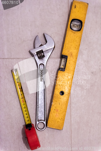 Image of set of hand working tools on ceramic tile background