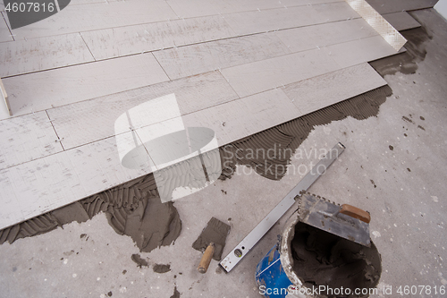 Image of Ceramic wood effect tiles and tools for tiler on the floor