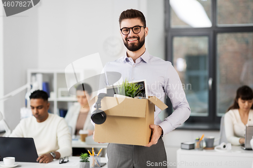 Image of happy male office worker with personal stuff