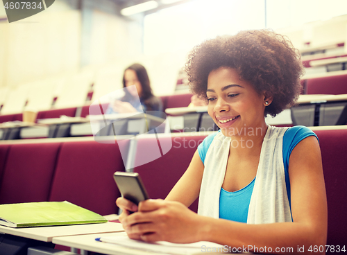 Image of african student girl with smartphone at lecture